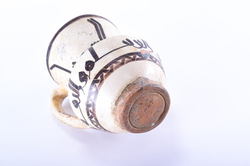 Lot 169 - An early Islamic tin glazed ewer, with...