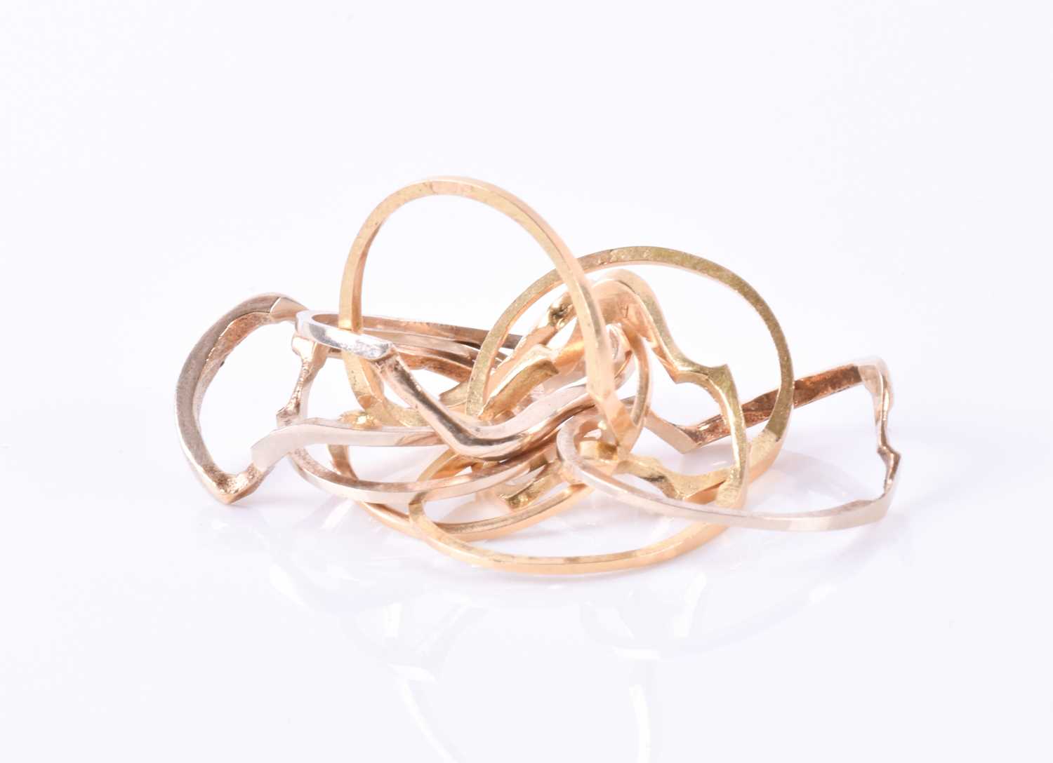 Lot 914 - A yellow metal puzzle ring comprising of eight...