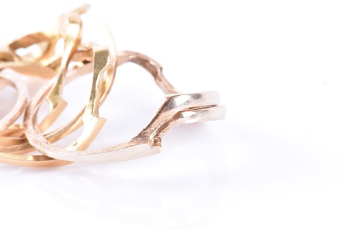 Lot 914 - A yellow metal puzzle ring comprising of eight...
