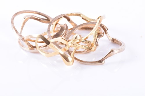 Lot 914 - A yellow metal puzzle ring comprising of eight...