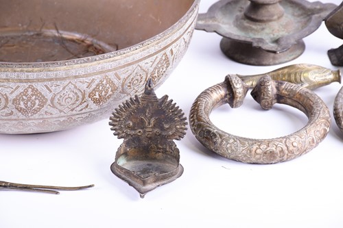 Lot 214 - A Tibetan cast bronze oil lamp, hentha weights,...