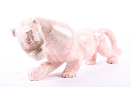 Lot 286 - A large pink hardstone model of a panther n...