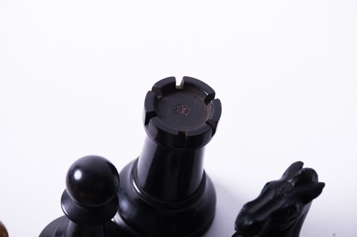 Lot 324 - A Staunton carved wood chess set, the rooks...