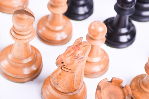 Lot 324 - A Staunton carved wood chess set, the rooks...