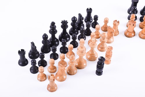 Lot 324 - A Staunton carved wood chess set, the rooks...