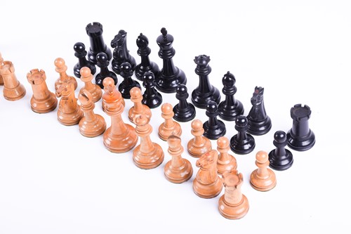 Lot 324 - A Staunton carved wood chess set, the rooks...