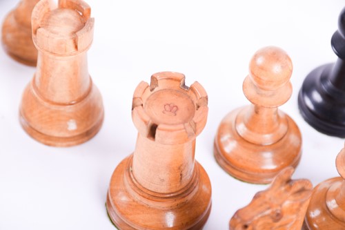 Lot 324 - A Staunton carved wood chess set, the rooks...