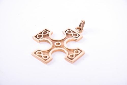 Lot 554 - A 9ct gold cross pendant designed by Ola Gorie,...