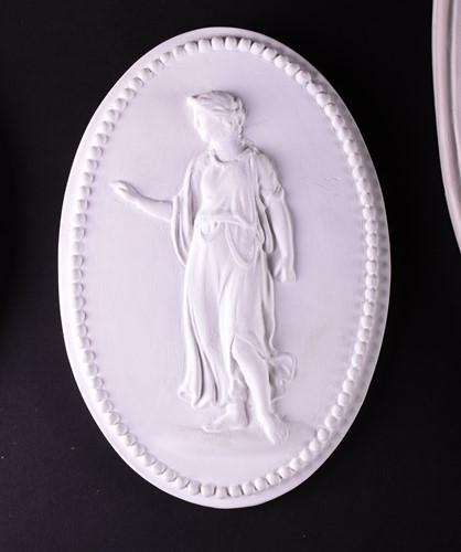 Lot 252 - A large 18th century style oval plaster relief...