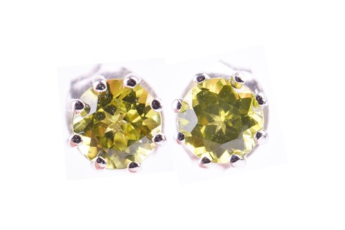 Lot 668 - A pair of 9ct white gold and peridot earrings...