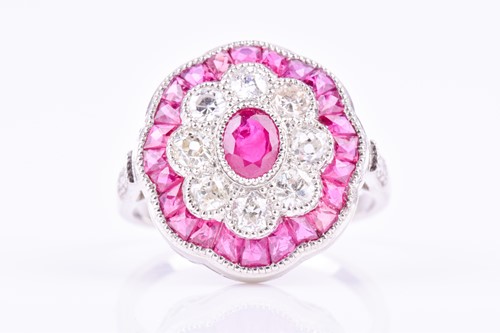 Lot 501 - A diamond and ruby cocktail ring centred with...