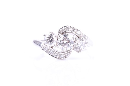 Lot 574 - An 18ct white gold and diamond trilogy...