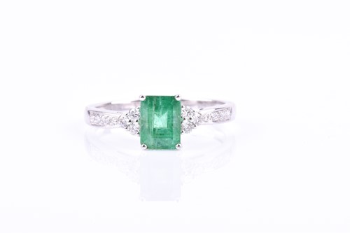 Lot 816 - A 14ct white gold, diamond, and emerald ring, ...