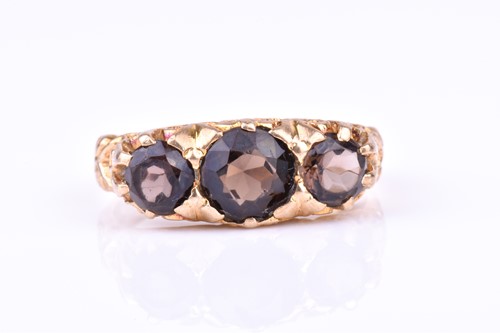 Lot 780 - A 9ct yellow gold and smokey quartz ring set...