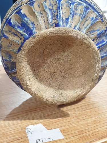 Lot 200 - A Persian blue glazed calligraphic jug,...