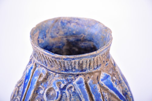 Lot 200 - A Persian blue glazed calligraphic jug,...