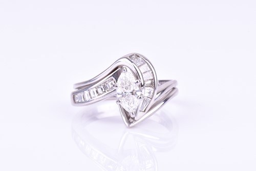 Lot 812 - A 14ct white gold and diamond ring centred...