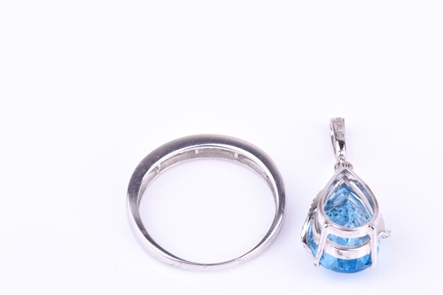 Lot 628 - A white gold, diamond, and blue topaz pendant...