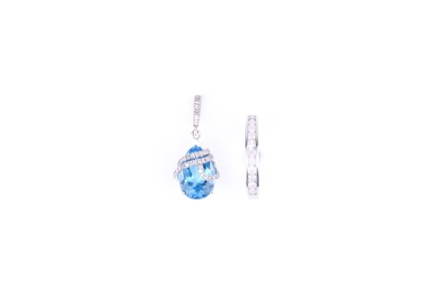 Lot 628 - A white gold, diamond, and blue topaz pendant...