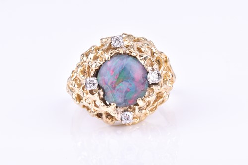 Lot 721 - A 14k yellow gold, diamond, and opal ring in...