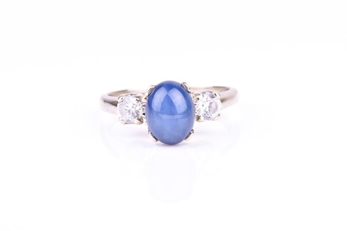 Lot 633 - A 14k white gold, star sapphire, and CZ ring...