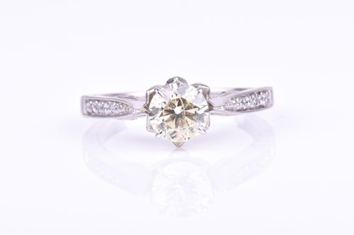 Lot 798 - A diamond solitaire ring set with a round...