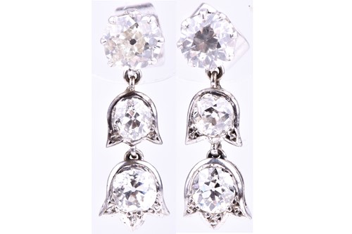 Lot 643 - A pair of diamond drop earrings set with an...