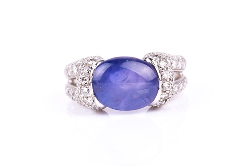 Lot 542 - A diamond and tanzanite ring, the double loop...