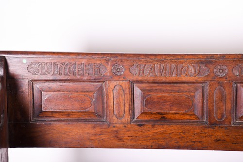 Lot 121 - An early 19th oak church pew, with cushioned...