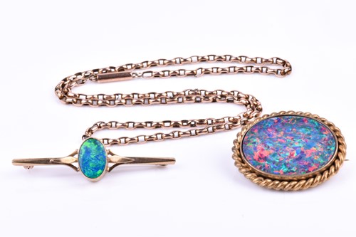 Lot 710 - A 9ct yellow gold and opal bar brooch, set...