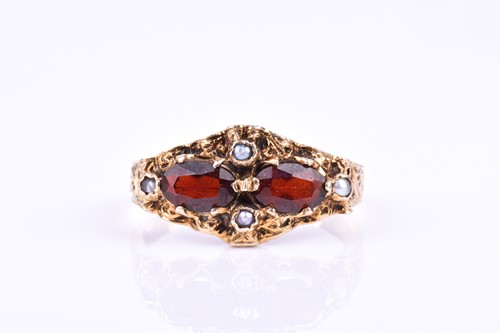 Lot 710 - A 9ct yellow gold, garnet, and pearl ring, set...