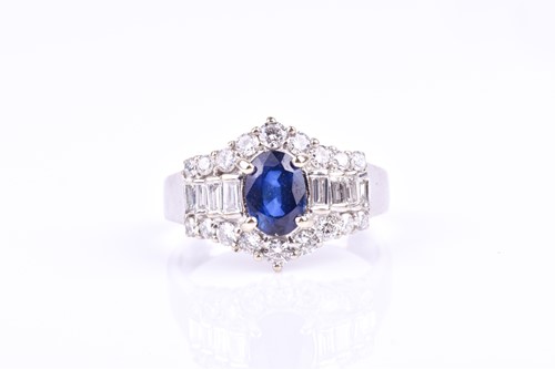 Lot 793 - An 18ct white gold, diamond, and sapphire ring,...