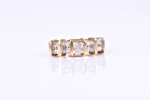 Lot 646 - A yellow metal and CZ ring, set with five...