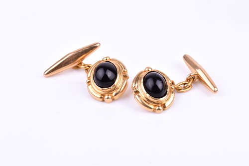 Lot 776 - A pair of yellow metal and black stone...