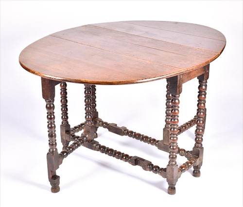 Lot 35 - An early 20th century oak gateleg table on...