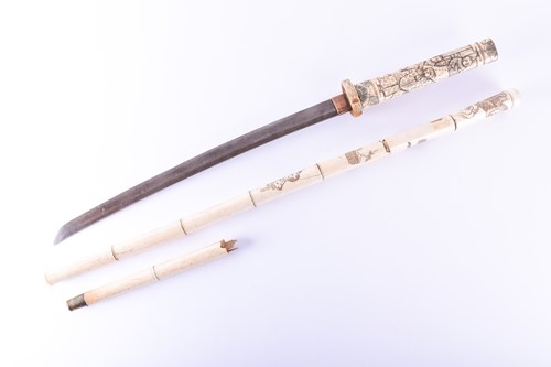 Lot 243 - A Japanese carved bone sword stick, circa 1900,...