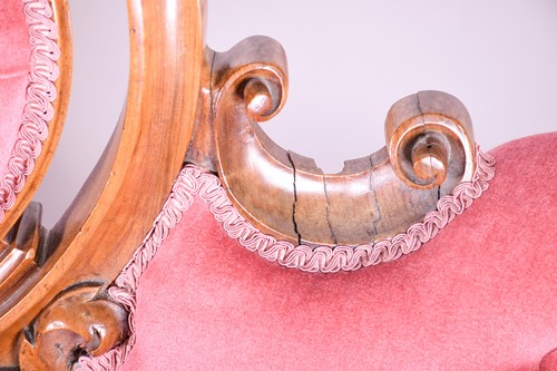 Lot 175 - A Victorian carved walnut salon settee, with...