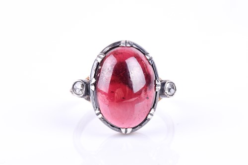 Lot 652 - An unusual diamond and garnet ring, set with...