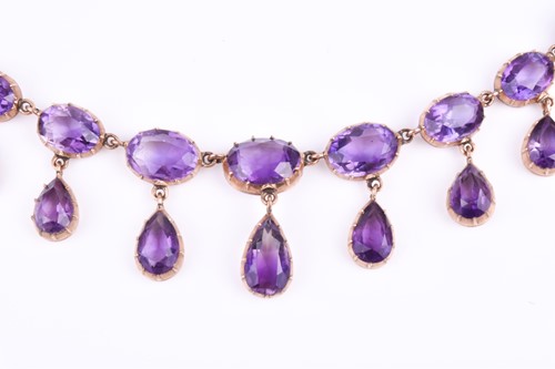 Lot 755 - A Victorian yellow gold and amethyst Riviere...