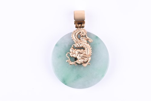 Lot 638 - A silver gilt and jade pendant, the mount in...