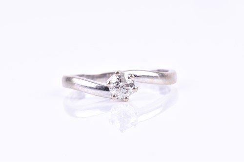 Lot 706 - A 9ct white gold and solitaire diamond ring,...