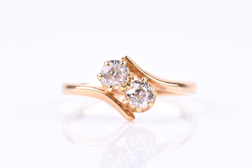 Lot 816 - An 18ct yellow gold and diamond crossover ring,...