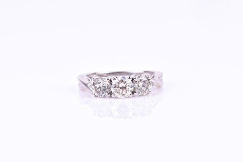 Lot 782 - A three stone diamond ring, set with a round...