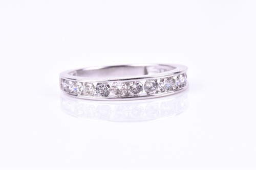 Lot 755 - A white gold and diamond half eternity ring,...