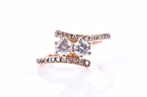 Lot 538 - A 14ct rose gold and diamond crossover ring,...