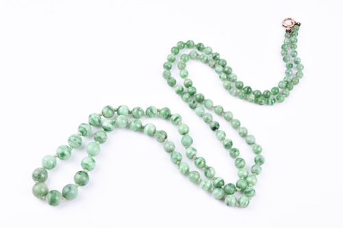 Lot 772 - A Chinese green jadeite necklace, comprised of...