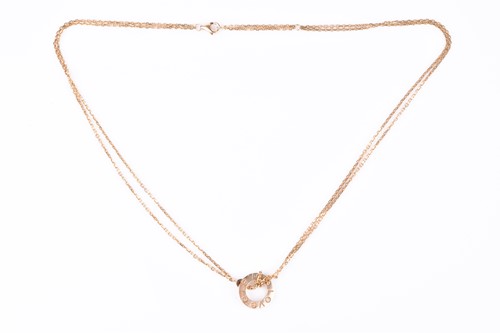 Lot 568 - Cartier. An 18ct yellow gold 'Love' pendant,...