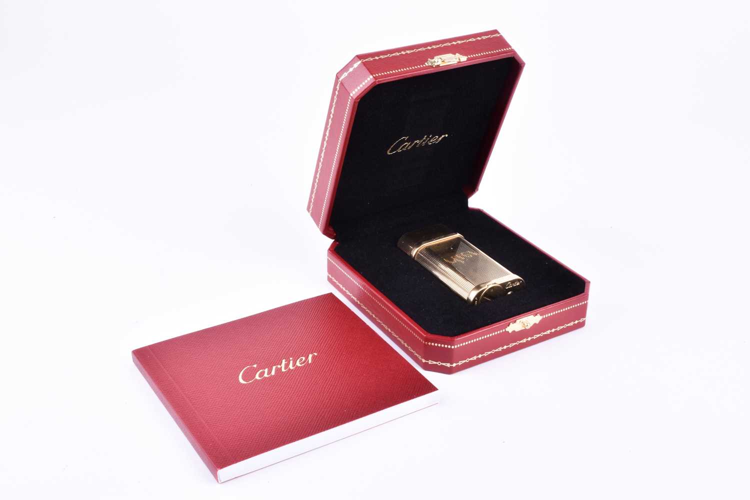 Lot 483 - Cartier. A silver gilt lighter, the case with...