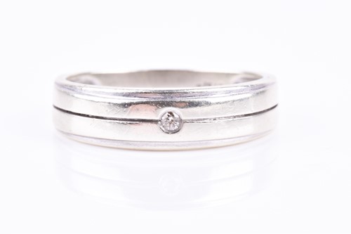 Lot 807 - A white metal gents ring, inset with a diamond...