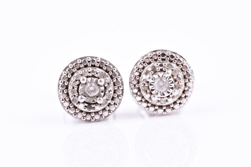 Lot 668 - A pair of white metal and diamond cluster ear...